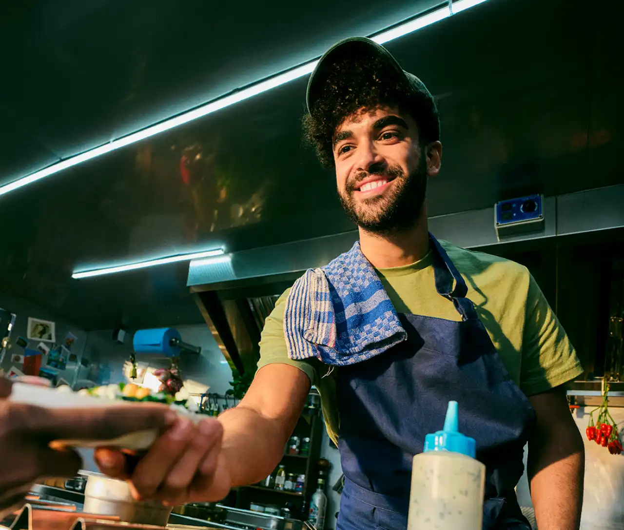 Cook from food truck serves food