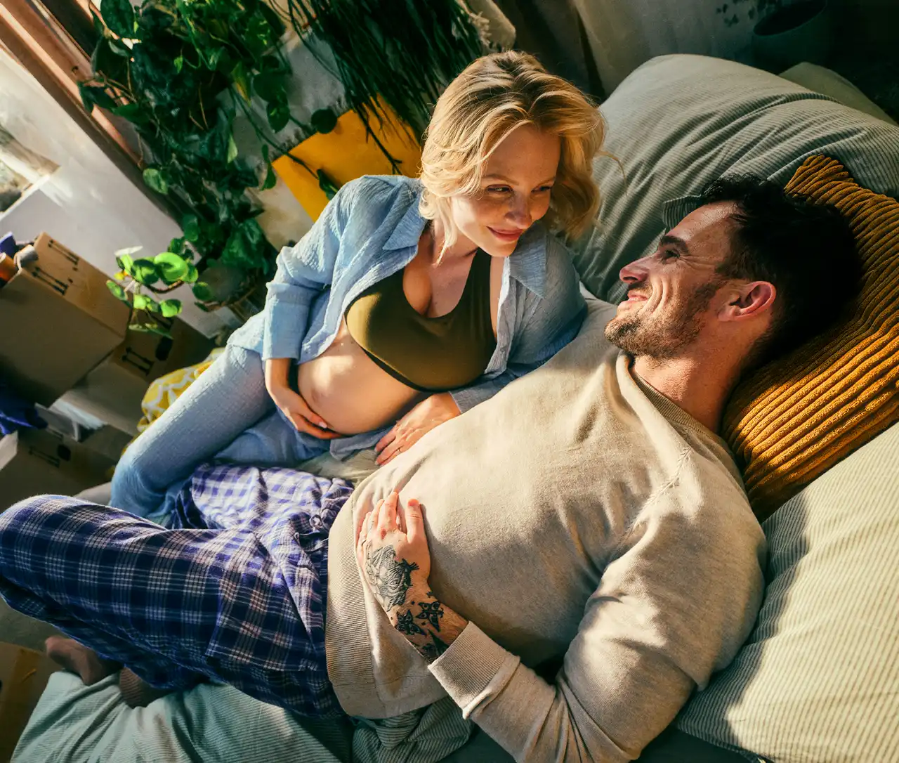 Man and pregnant woman on sofa bed