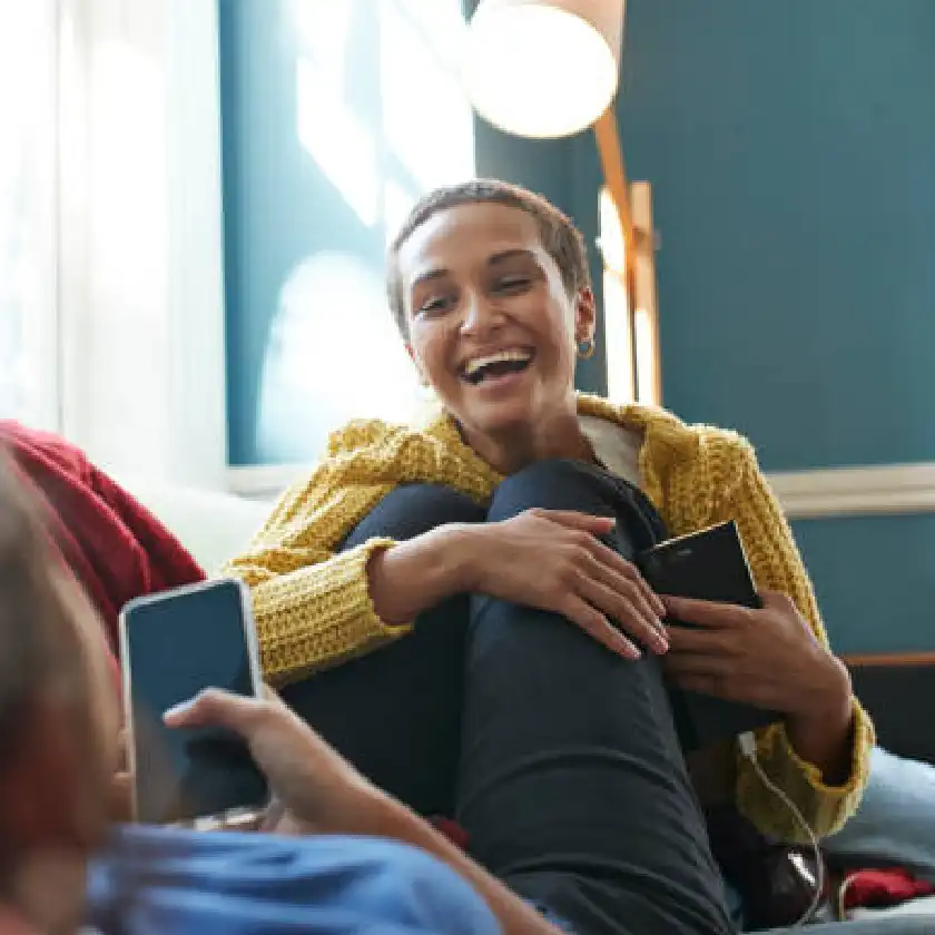 Couple with mobile phones on sofa