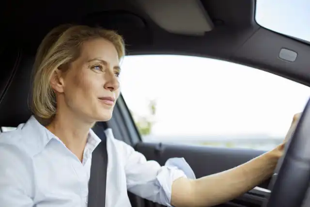 Blonde woman drives car