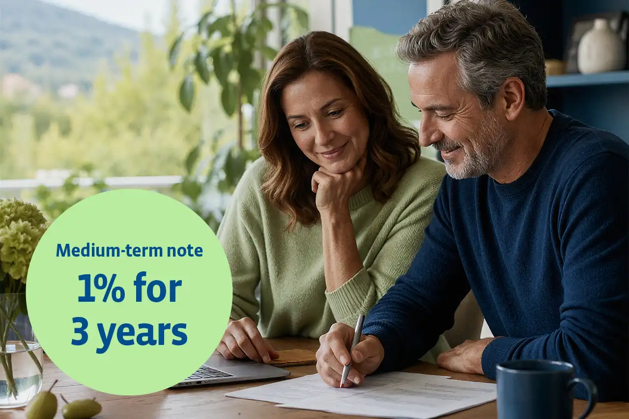 Man and woman at the breakfast table going through documents