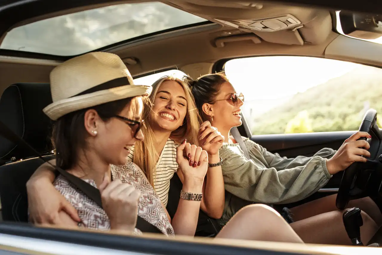 Three women sit in the car